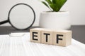 ETF word on wood blocks concept with chart, coins, notebook , glasses Royalty Free Stock Photo