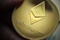 ETH Ether Ethereum Golden Cryptocurrency Coin. Closeup