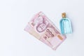 Ethanol alcohol in glass bottle with Thai banknote on white background