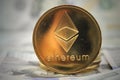 Ether ETH Ethereum coin on hundred dollars bills. Close-up, macro shot