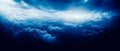 Ethereal clouds in dark navy and white, dreamlike horizons, aerial view with chiaroscuro. Realistic yet dreamy atmosphere