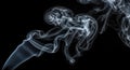 Ethereal Dance of Smoke Swirling White Vapor Against a Black Backdrop Creates a Mesmerizing Visual Texture Royalty Free Stock Photo