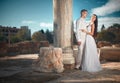 Ethereal, divine bride with shiny dress and groom standing near Royalty Free Stock Photo