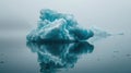 Ethereal iceberg on calm waters with foggy mountain backdrop. Royalty Free Stock Photo