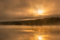 Ethereal moody sunrise with fog and steam being illuminated over a lake. Croton Gorge Royalty Free Stock Photo