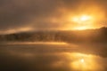 Ethereal moody sunrise with fog and steam being illuminated over a lake. Croton Gorge Royalty Free Stock Photo