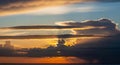 Dramatic Sunset Sky with Rays of Light Breaking Through Dark Clouds Over a Calm Body of Water Keywords: sunset, sky Royalty Free Stock Photo