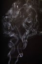 Ethereal Smoke Dance Against Dark Background