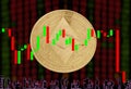 Ethereum Classic Cryptocurrency Gold Coin ETC Round against the background of blurry numbers and a chart candlestick.