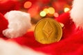 Ethereum coin with Christmas holiday season decoration, coin stack and Santa Claus hat