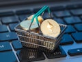 Ethereum coins in shopping basket on laptop keyboard. Ethereum wallet and payment