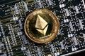 Ethereum ETH gold coin representing cryptocurrencies, against a computer circuit background