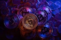 Ethereum on piled up Dollar coins and Bitcoin cryptocurrency coin