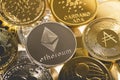 Ethereum silver coin against the background of other golden coins. Electronic virtual cryptocurrency for online banking. Royalty Free Stock Photo