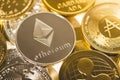 Ethereum silver coin against the background of other golden coins. Electronic virtual cryptocurrency for online banking. Royalty Free Stock Photo