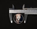 Ethereum silver coin on black background with risk measuring tool