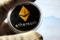 Ethereum silver metal coin in capsule and gold rhombus symbol of cryptocurrency