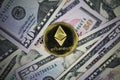 Ethereum Golden Cryptocurrency Coin Lying on a Money Background