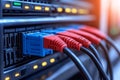 Ethernet cables plugged into a network switch with glowing blue and red connectors representing fast and secure data connection