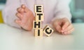 ETHIC word on a wooden cubes on a light background