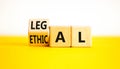 Ethical or legal symbol. Businessman turns wooden cubes and changes the word Ethical to Legal on a Beautiful yellow table white Royalty Free Stock Photo