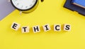 ETHICS word concept made with building blocks, yellow background Royalty Free Stock Photo