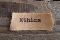 Ethics word on a piece of paper close up, business creative motivation concept Royalty Free Stock Photo