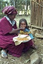 Ethiopian woman gives daughter injera to eat