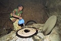 Ethiopian woman bakes injera on wood fire