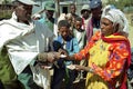 Ethiopian farmer receives money for sale corn