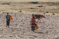 Ethiopian farmer woman walking with water canister