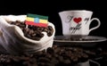 Ethiopian flag in a bag with coffee beans isolated on black