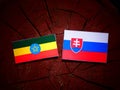 Ethiopian flag with Slovakian flag on a tree stump isolated