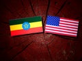 Ethiopian flag with USA flag on a tree stump