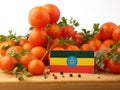 Ethiopian flag on a wooden panel with tomatoes isolated on a whi