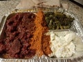 Ethiopian kitfo raw beef in tray with cheese and greens and spices