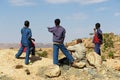 Ethiopian teenager boys enjoy the rural view to the Debre Damo monastery area from a viewpoint in Tigrai, Ethiopia.