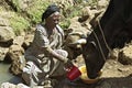 Ethiopian woman fetch water from natural well Royalty Free Stock Photo