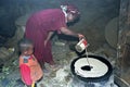 Ethiopian woman with son bakes injera on wood fire Royalty Free Stock Photo