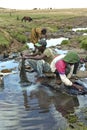 Ethiopians washing clothes in a running stream