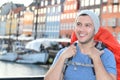 Ethnic backpacker smiling in the epic Nyhavn, Copenhagen, Denmark Royalty Free Stock Photo