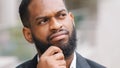 Ethnic bearded African American man think deep in thoughts. Adult entrepreneur pensive manager executive thoughtful Royalty Free Stock Photo