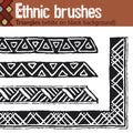 Ethnic brushes. Triangles white on black background