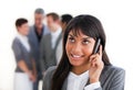 Ethnic businesswoman on phone in front of her team Royalty Free Stock Photo