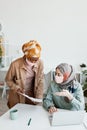 Ethnic Businesswomen Wearing Masks at Work