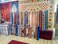 Ethnic carpet, ornamental folk bags, many ornate pillows with embroidery in asian shop, store. Asian market, trade fair