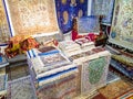 Ethnic carpet, ornamental folk bags, many ornate pillows with embroidery in asian shop, store. Asian market, trade fair