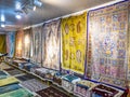 Ethnic carpet, ornamental folk bags, many ornate pillows with embroidery in asian shop, store. Asian market, trade fair