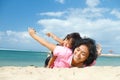 Ethnic child fun with mother on tropical beach