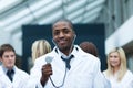 Ethnic doctor with his team in the background Royalty Free Stock Photo